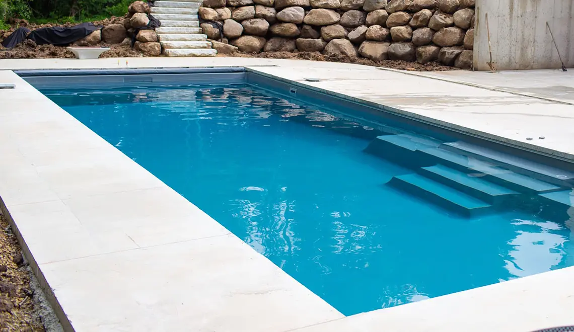 [exp_site_title] The Grand fiberglass pool with a large rectangular shape great for swimming.